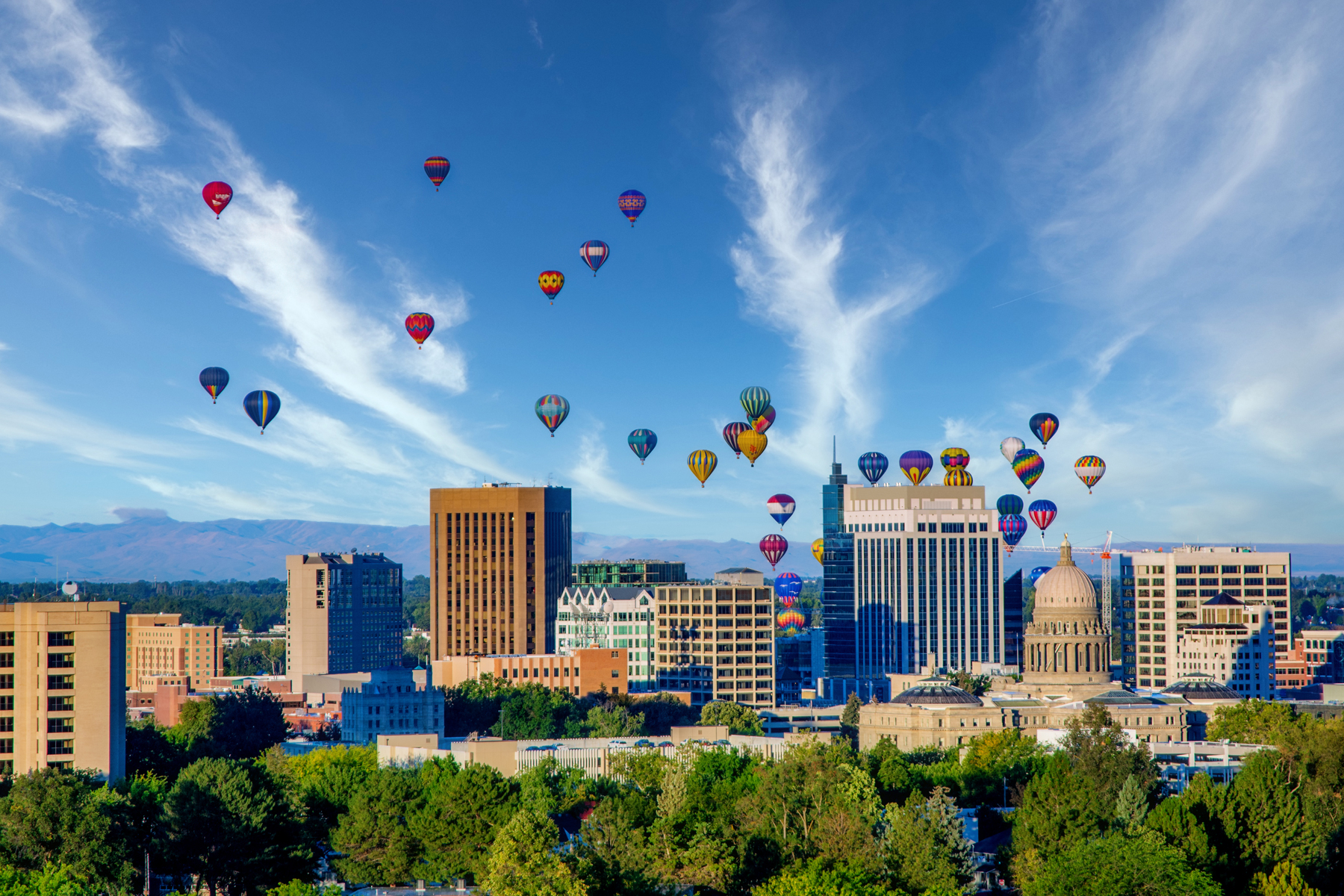 Hot air balloons above the downtown Boise skyline and Idaho State Capitol.