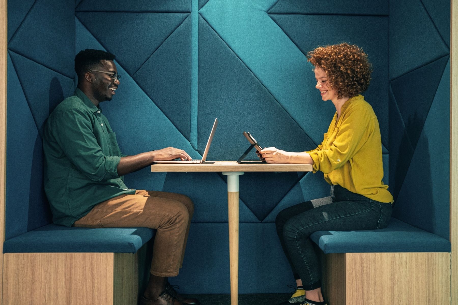 Employees using a laptop and tablet in a connected workplace