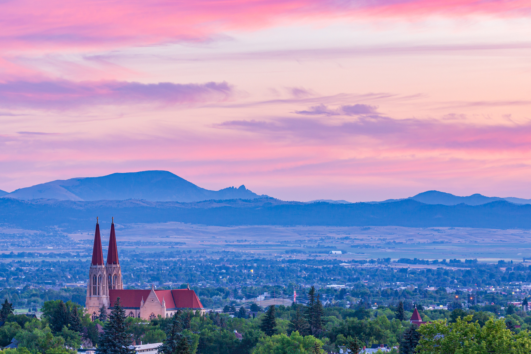 Cathedral of Saint Helena overlooking Helena, Montana, and the surrounding mountains at sunset.