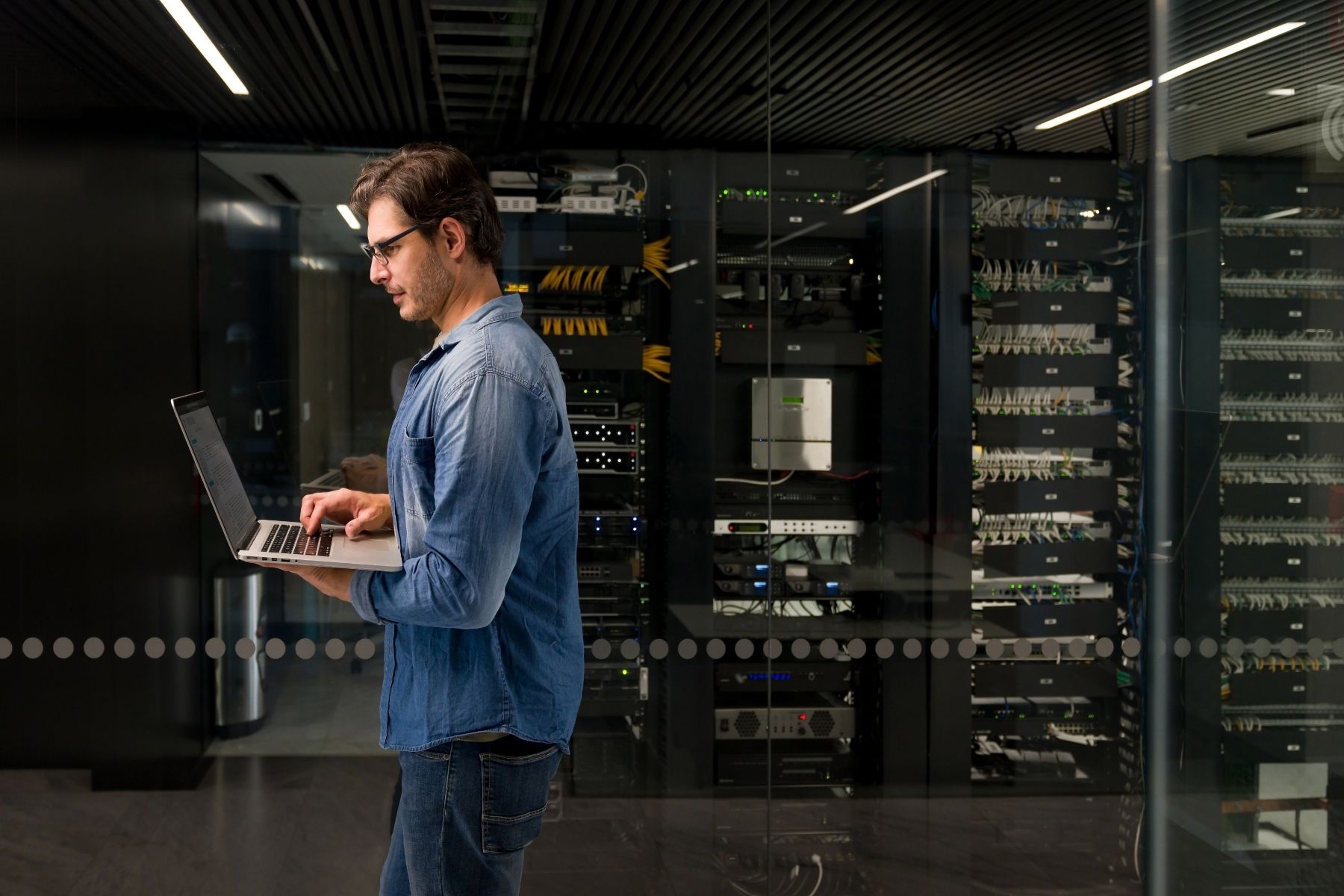 IT professional managing data center infrastructure from a laptop